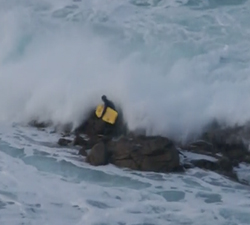 bodyboarder washed over rocks